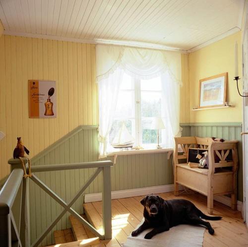 a dog laying on the floor in a room at Villa Lilla Pärla in Virserum