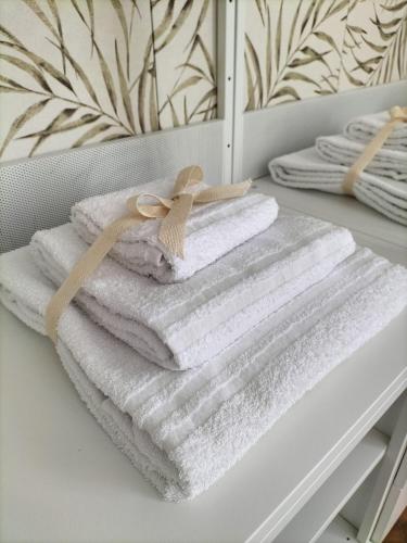 a pile of towels sitting on a shelf in a bathroom at La Casita in Castelfidardo