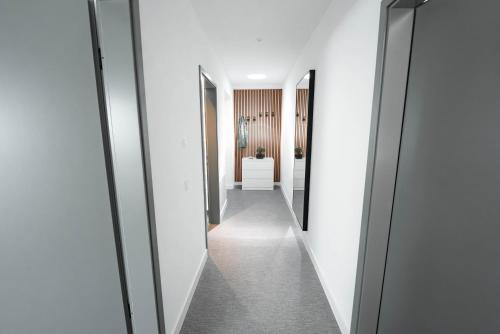 a hallway with white walls and a row of mirrors at Boutique Hotel GreenLeaf in Sinzing