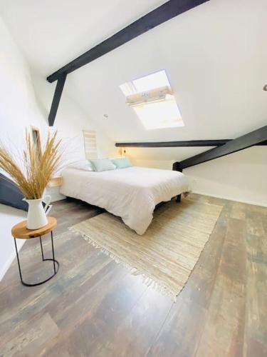 - une chambre mansardée avec un lit et une table dans l'établissement La Rochelle Royale - Ville, à La Rochelle