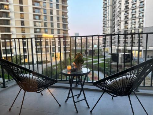 two chairs and a table on a balcony with a view at Waterfront Retreat with Garage and Balcony in Belgrade
