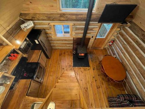 an overhead view of a kitchen in a tiny house at Wind Down Log Cabin in the Woods with Cozy Woodstove in Qualicum Beach