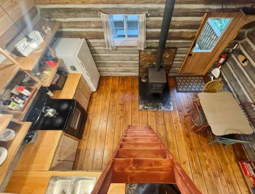 an overhead view of a kitchen with a wooden floor at Slow-Go Log Cabin in the Woods with Cozy Woodstove in Qualicum Beach