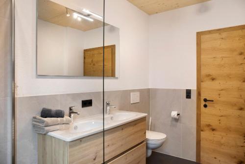 a bathroom with a sink and a toilet at Apart Mountainview in Rohrberg