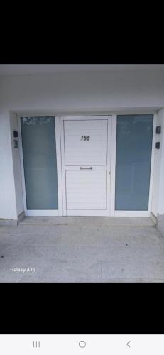 a garage with three glass doors in a building at Appartement Almadrava Roses in Roses
