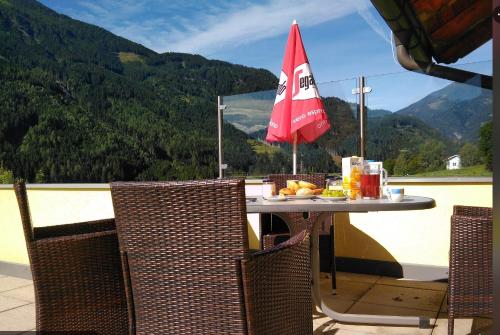 a table with a plate of food on top of a balcony at Appartementhaus Flattach Goritschnig in Flattach