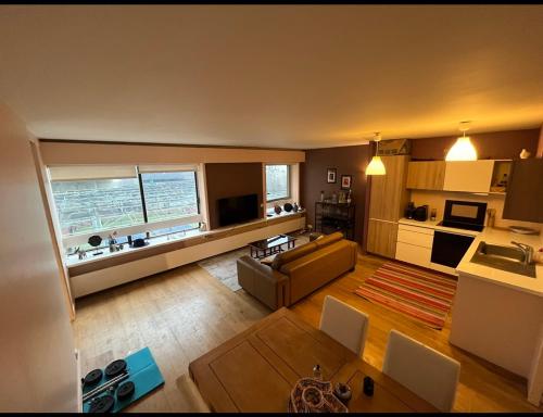 Il comprend un grand salon avec un canapé et une cuisine. dans l'établissement Central Charm 10min walk Eiffel tower, à Paris