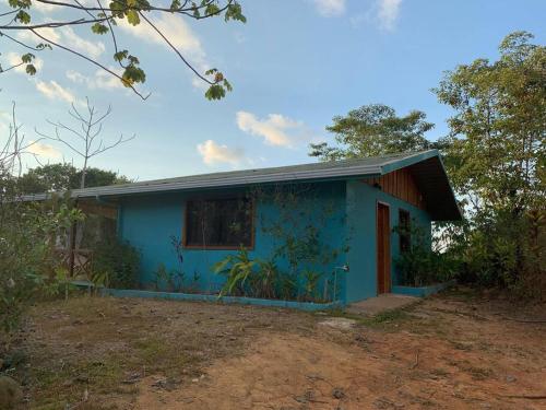 a blue house in the middle of a field at Villa Cecropia Drake in Drake