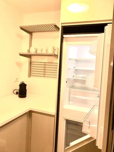 a refrigerator with its door open in a kitchen at Large Taverna 2BR 2BA Steps to Lift Full Kitchen in Courmayeur
