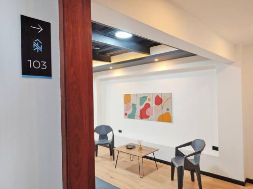 a dining room with two chairs and a table at Cómodo apartamento en San Vicente - Cali in Cali