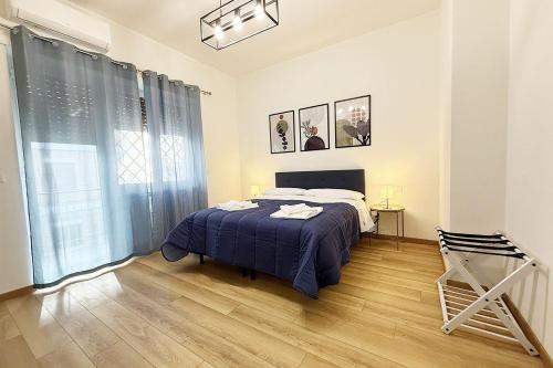 a bedroom with a bed and a wooden floor at Lorena Cozy Rooms - Ospedale Gemelli - WiFi in Rome