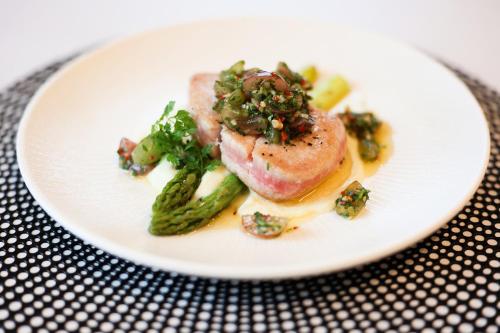 a plate of food with broccoli on a table at Suncity Hotel & SPA in Šiauliai
