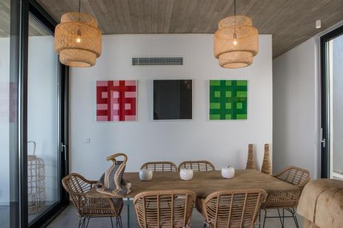 a dining room with a wooden table and chairs at Magic Cave Villa in Tinos in Agios Sostis