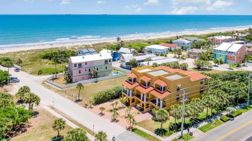 an aerial view of a beach with buildings and the ocean at the Cape House in Cape Canaveral