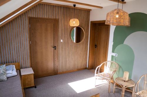 a room with a table and chairs and a door at Zajazd w Biskupinie in Biskupin