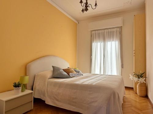 a bedroom with a white bed and a window at Ba Cio Del Mare by Holiday World in Cogoleto