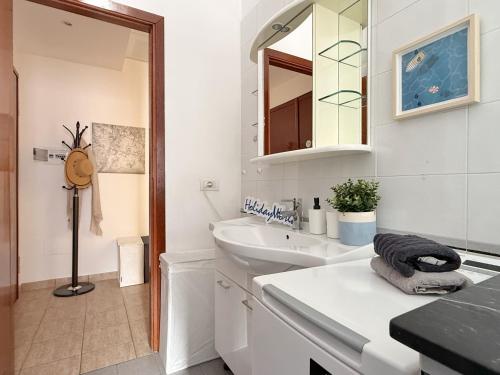 a white bathroom with a sink and a mirror at Ba Cio Del Mare by Holiday World in Cogoleto