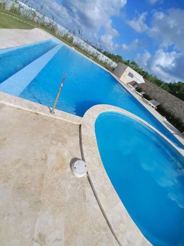 an overhead view of a swimming pool with blue water at Pool Feelings Punta Cana in Punta Cana