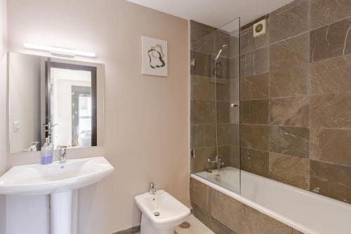 a bathroom with a sink and a toilet and a shower at The Sunset Apartment - 2 BR & Beach-Front in Tangier
