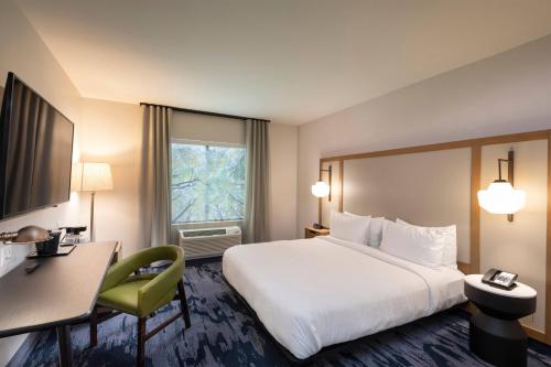 a hotel room with a large bed and a desk at Fairfield Inn & Suites Arkadelphia in Arkadelphia