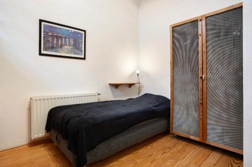 a bedroom with a bed and a sliding glass door at Ferienhaus Poggenkrug Halbsguth in Wolgast