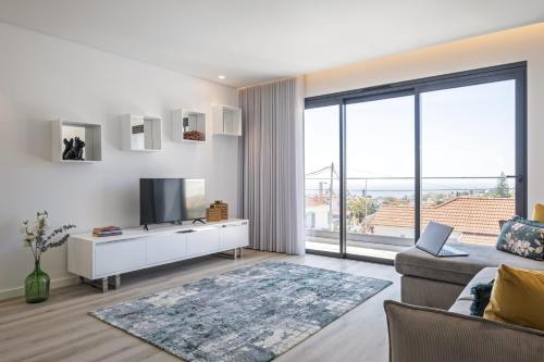 a living room with a television and a couch at Contemporary Residence C by Homie in Funchal