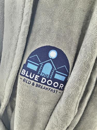 a blue door badge on a gray shirt at The Blue Door in Letterkenny