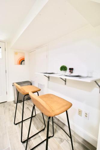 two chairs in a kitchen with white cabinets at Studio Apartment near RFK fields in Washington, D.C.