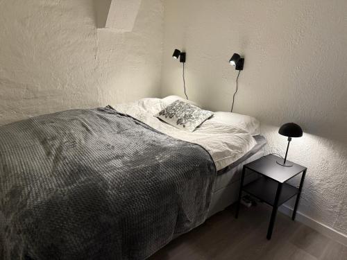 a bedroom with a bed and a side table at Modern familjelägenhet in Sundsvall