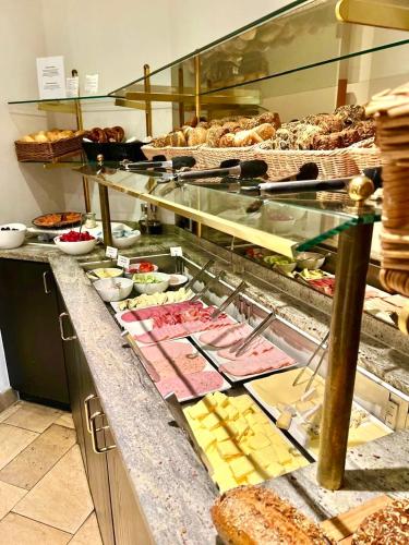a buffet line with many different types of food at Hotel Erzgiesserei Europe in Munich