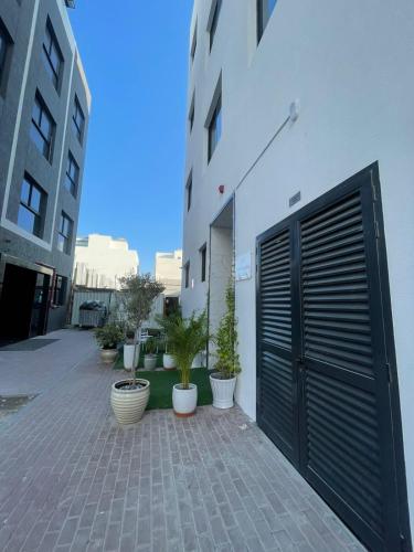 a building with a black garage door and potted plants at Ista Vacation Homes Rental LLC in Dubai
