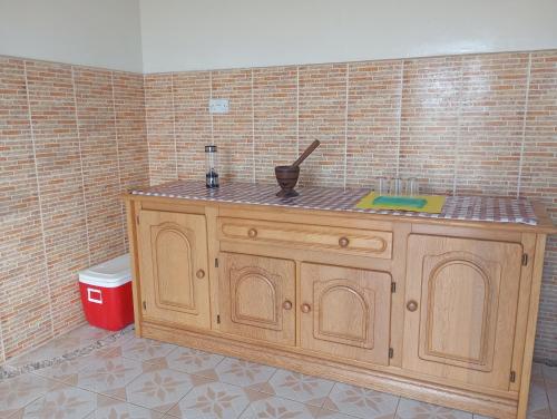 a kitchen with a wooden counter in a room at Baafeh Beach in Sanyang