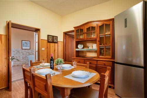 a dining room with a table and a refrigerator at Casa Dayaday in Puerto del Rosario