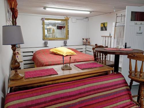 a bedroom with two beds and a table with a mirror at Paisible escale chez l'habitant in Vitry-sur-Seine
