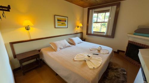 VELINN Recanto das Hortencias Hotelにあるベッド