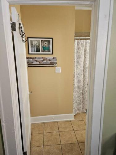 a hallway with a window and a picture on the wall at The Stake at Chestnut Place in Greenville