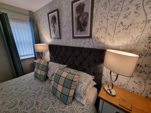a bedroom with a bed with two pillows and two lamps at Anchor House 2 East Street Alford Lincolnshire LN13 9EQ in Alford