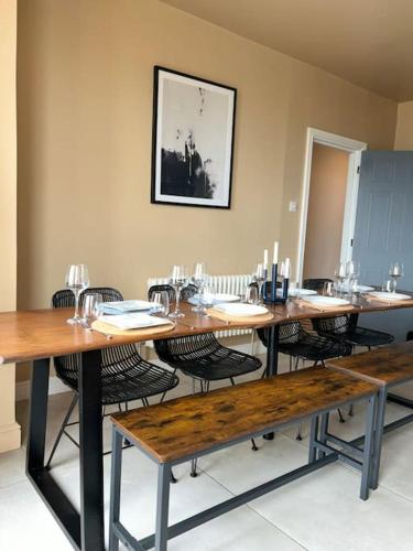 a room with a long table with chairs and a picture at Georgian Townhouse on the beach in Worthing