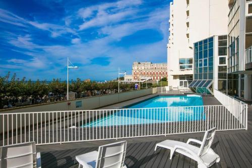 - une piscine sur un balcon avec 2 chaises dans l'établissement BIARRITZ GRANDE PLAGE - STUDIO AVEC BALCON - Victoria Surf, à Biarritz