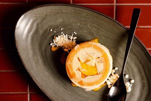 a gray plate with a piece of fruit on it at Pan Pacific London in London