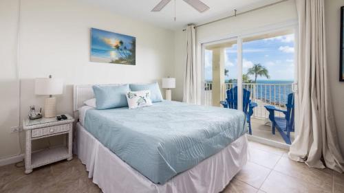a bedroom with a bed and a view of the ocean at Whispering Palms Sea Gulls 210 in Key Largo