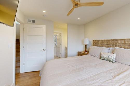 a bedroom with a white bed and a ceiling fan at Towering Pine in Incline in Incline Village