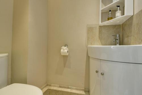 a bathroom with a white toilet and a sink at The Farmhouse West Anstey in West Anstey