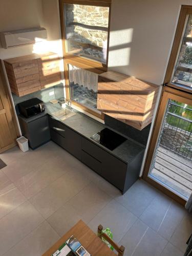 an overhead view of a kitchen with wooden cabinets at Chalet Letizia Mountain and Relax - Your Mountain Holiday in Premana