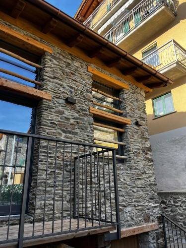 a stone facade of a house with a balcony at Chalet Letizia Mountain and Relax - Your Mountain Holiday in Premana
