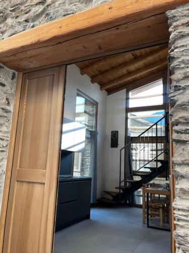 a door to a room with a stone wall at Chalet Letizia Mountain and Relax - Your Mountain Holiday in Premana