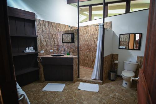 a bathroom with a shower and a sink and a toilet at Chilamate Rainforest Eco Retreat in Puerto Viejo