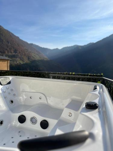 a white bath tub with a view of mountains at Chalet Letizia Mountain and Relax - Your Mountain Holiday in Premana