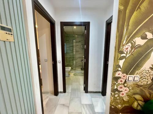 a bathroom with a walk in shower and a toilet at Jungle Vibes Stay - 2 BR Beach Front & Balcony in Tangier