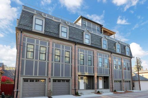 a large brick building with a gambrel roof at The Golden Hour - Luxury and Rooftop Hot Tub in Columbus